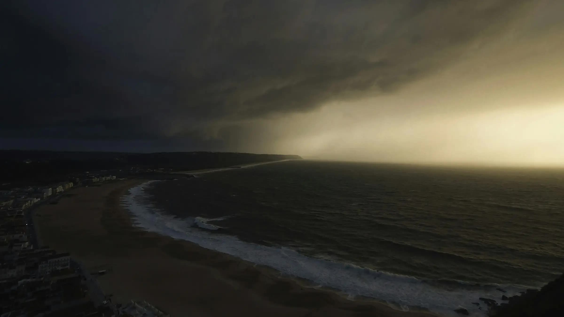 A dark storm front rolling in over the coast