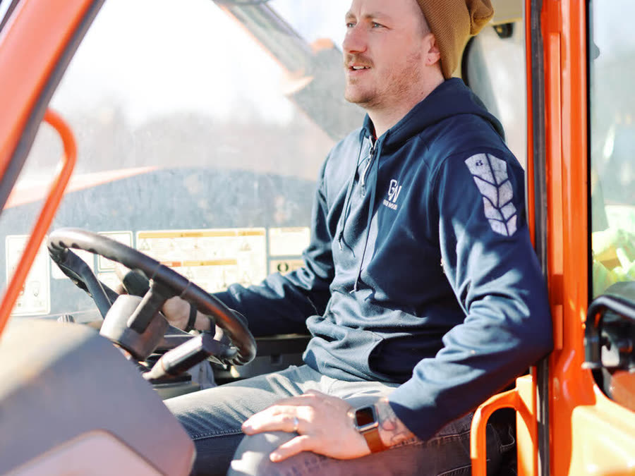 A Good Wood crew member operating a telehandler on site