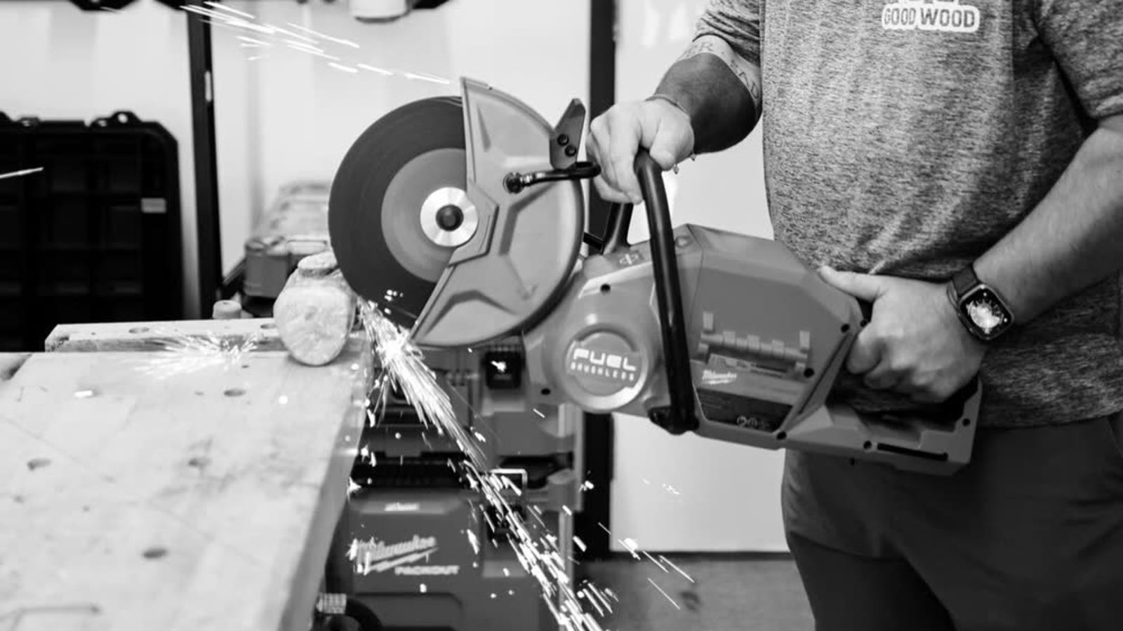 A saw throwing sparks as it cuts through metal in a shop